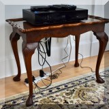 F19. Carved side table with burlwood top. 22”h x 27”w x 17”d 